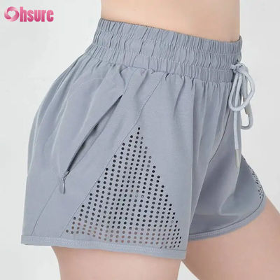 Groothandel Vrouwen Sport Workout Shorts ademend laser gesneden joggen Shorts met warmte-up Zipper Side Pocket Solid Pattern