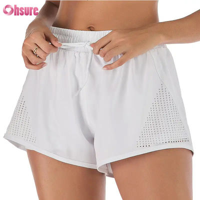 Groothandel Vrouwen Sport Workout Shorts ademend laser gesneden joggen Shorts met warmte-up Zipper Side Pocket Solid Pattern
